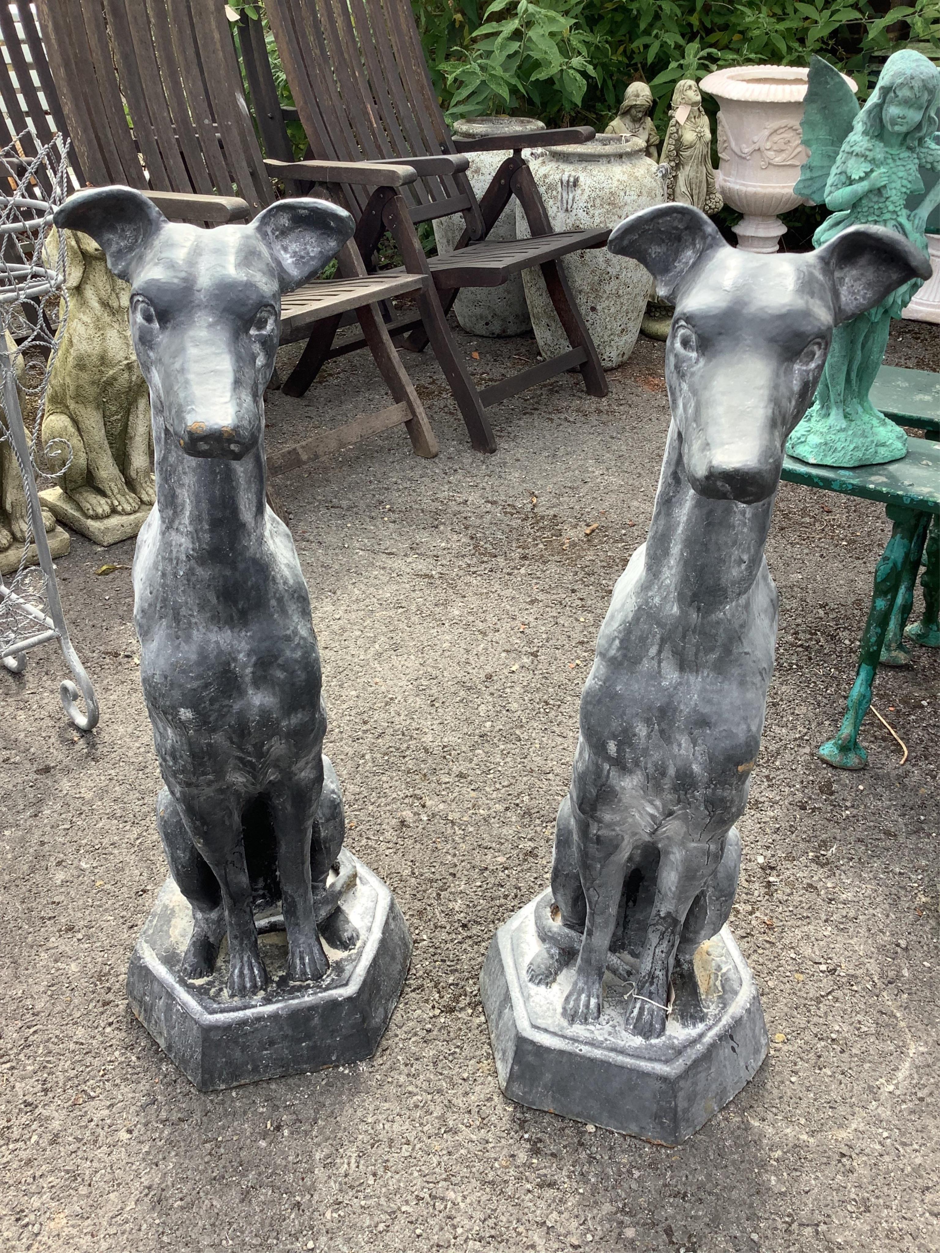 A pair of cast iron faux lead sitting hound garden ornaments, height 92cm. Condition - good